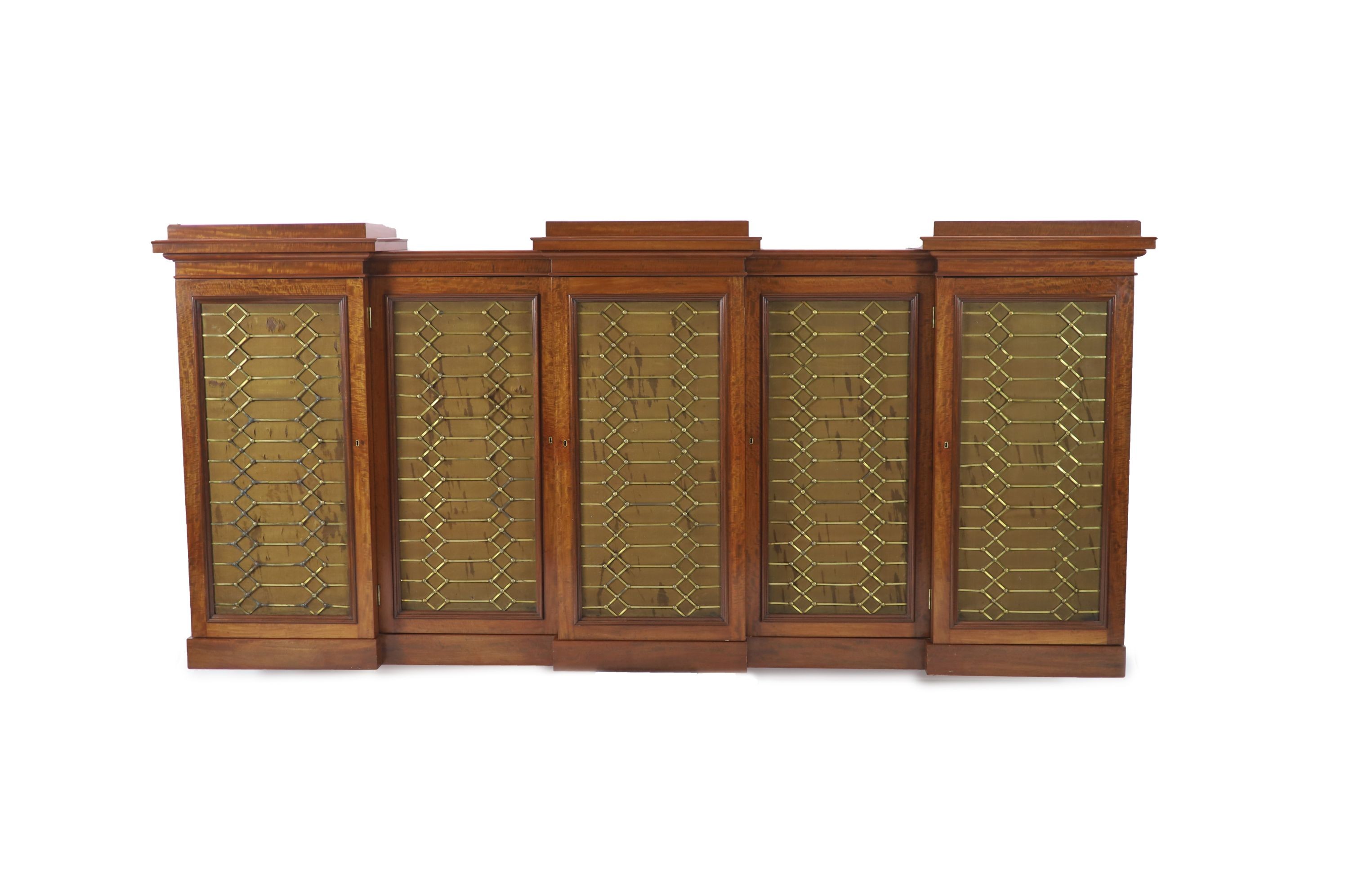 An early Victorian flame mahogany triple breakfront library cabinet, W.330cm D.51cm H.152cm